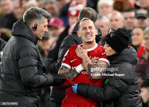Kostas Tsimikas of Liverpool receives medical treatment during the Premier League match between Liverpool FC and Arsenal FC at Anfield on December...