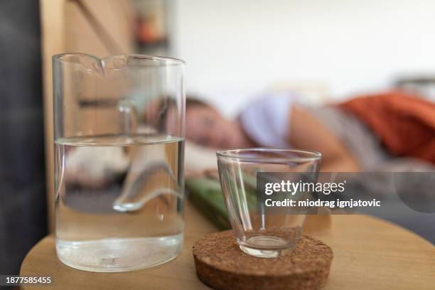 water next to bed - bedside table stock pictures, royalty-free photos & images