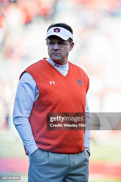 Head Coach Gus Malzahn of the Auburn Tigers watches his team warm up before a game against the Arkansas Razorbacks at Razorback Stadium on November...