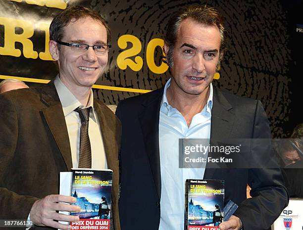 Herve Jourdain, Quai Des Orfevres 2014 award winner for his book 'Le Sang De La Trahison', and Jean Dujardin attend the Quai Des Orfevres 2014...