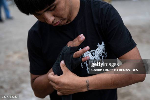 An inhabitant of the province of Chumbivilcas, in Cuzco, southern Peru, gets ready before celebrating Takanakuy in San Juan de Lurigancho, on the...