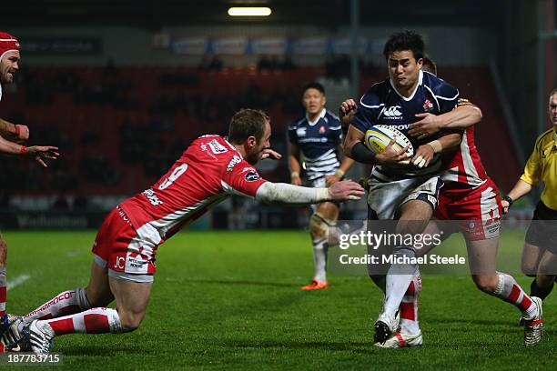 Yu Tamura of Japan is hallenged by Jimmy Cowan of Gloucester during the International match between Gloucester and Japan at Kingsholm Stadium on...