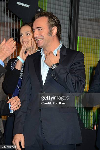 Sophie de Closets, Jean Dujardin and a guest attend the Quai Des Orfevres 2014 Literary Prize award announcement at the Police Judiciaire on November...