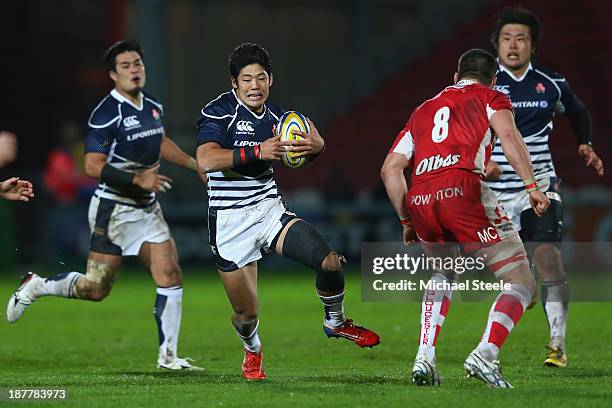 Yoshikazu Fujita of Japan runs at Matt Cox of Gloucester during the International match between Gloucester and Japan at Kingsholm Stadium on November...