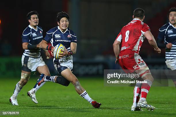 Yoshikazu Fujita of Japan runs at Matt Cox of Gloucester during the International match between Gloucester and Japan at Kingsholm Stadium on November...