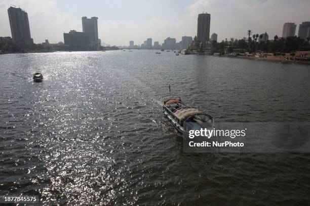 People are walking on the Qasr Al Nile Bridge during a sunny day in Cairo, Egypt, on December 26, 2023.