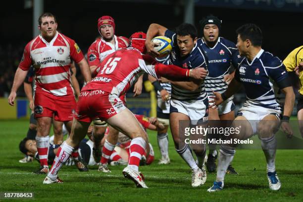 Atsushi Hiwasa of Japan is held up by Rob Cook of Gloucester during the International match between Gloucester and Japan at Kingsholm Stadium on...