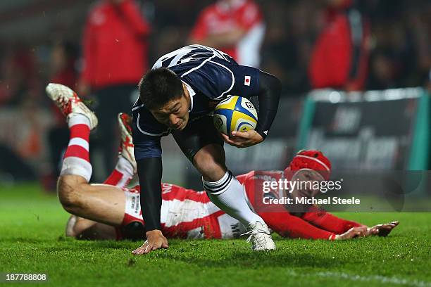 Kotaro Matsushima of Japan leaves Rob Cook of Gloucester grounded during the International match between Gloucester and Japan at Kingsholm Stadium on...