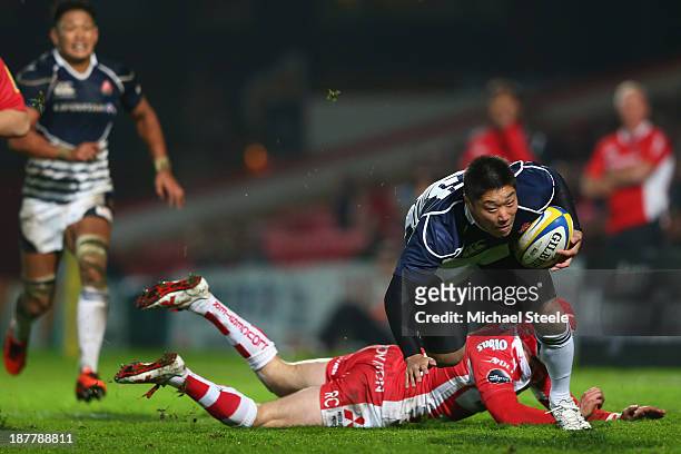 Kotaro Matsushima of Japan leaves Rob Cook of Gloucester grounded during the International match between Gloucester and Japan at Kingsholm Stadium on...