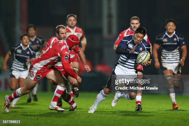 Kotaro Matsushima of Japan races past Rob Cook of Gloucester during the International match between Gloucester and Japan at Kingsholm Stadium on...