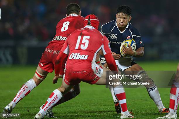 Takashi Kikutani of Japan challenged by Matt Cox and Rob Cook of Gloucester during the International match between Gloucester and Japan at Kingsholm...