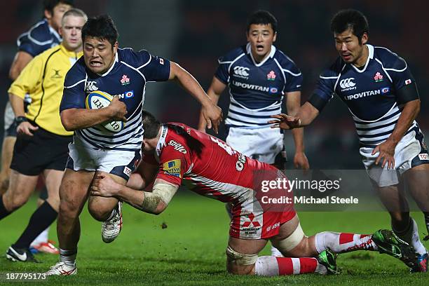 Takuma Asahara of Japan is tackled by Elliott Stooke of Gloucester during the International match between Gloucester and Japan at Kingsholm Stadium...