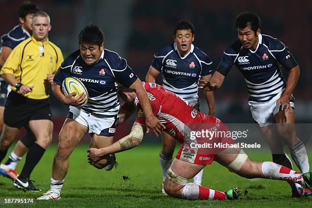 Takuma Asahara of Japan is tackled by Elliott Stooke of Gloucester during the International match between Gloucester and Japan at Kingsholm Stadium...