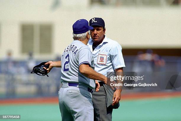 Major League Baseball umpire Ed Montague listens to Los Angeles Dodgers manager Tommy Lasorda during a game against the Pittsburgh Pirates at Three...