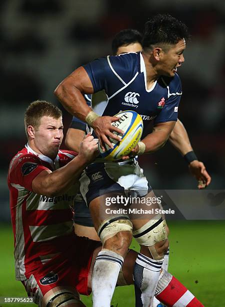 Takashi Kikutani of Japan is held up by Ross Moriarty of Gloucester during the International match between Gloucester and Japan at Kingsholm Stadium...