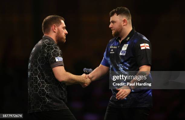 Berry van Peer of Netherlands interacts with Josh Rock of Northern Ireland during day nine of the 2023/24 Paddy Power World Darts Championship at...