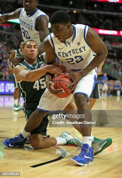 Denzel Valentine of the Michigan State Spartans grabs Alex Poythress of the Kentucky Wildcats during the State Farm Champions Classic at the United...