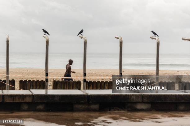 Holidaymaker braves the inclement weather and gathers on the North beach during Boxing Day festivities in Durban on December 26, 2023. The city...