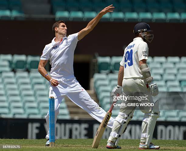 England Ashes Test cricketer Steven Finn runs in to bowl past batsman Ben Rohrer during the tour match against a Cricket Australia Invitational XI at...