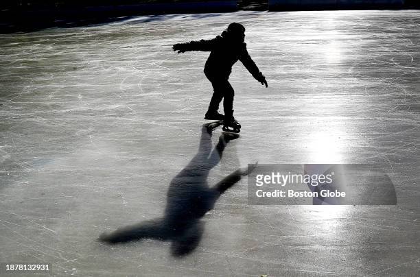 Boston, MA A skater is silhouetted on the Boston Common Frog Pond skating rink which is now open for skating.