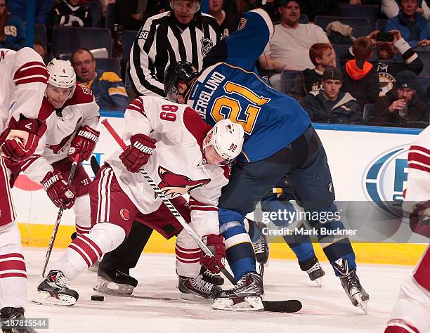 Mikkel Boedker of the Phoenix Coyotes faces off against Patrik Berglund of the St. Louis Blues on November 12, 2013 at Scottrade Center in St. Louis,...