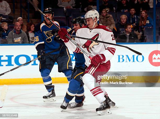 Michael Stone of the Phoenix Coyotes skates against Derek Roy of the St. Louis Blues on November 12, 2013 at Scottrade Center in St. Louis, Missouri.