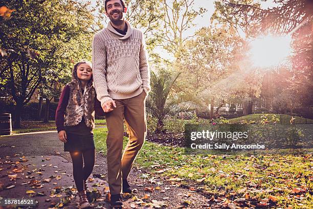 father and daughter walking in the park together - season 5 - fotografias e filmes do acervo