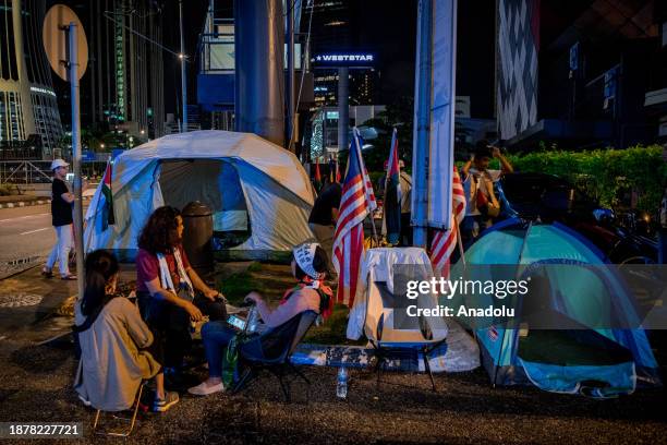 Demonstrators holding banners and Palestinian flags set up tents as they gather near the United States embassy in solidarity with Palestinian people...