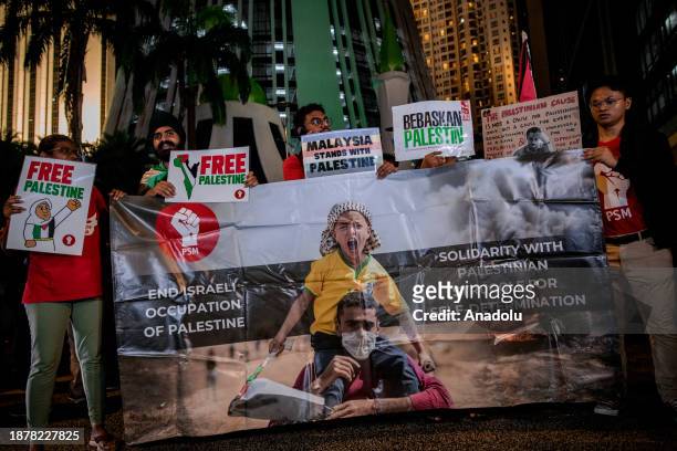 Demonstrators holding banners and Palestinian flags gather near the United States embassy in solidarity with Palestinian people during the 'Kepung...