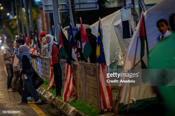 Demonstrators holding banners and Palestinian flags set up tents as they gather near the United States embassy in solidarity with Palestinian people...