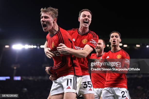 Rasmus Hojlund of Manchester United celebrates scoring their 3rd and winning goal with Jonny Evans during the Premier League match between Manchester...