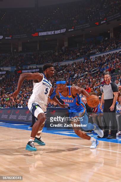 Shai Gilgeous-Alexander of the Oklahoma City Thunder dribbles the ball during the game against the Minnesota Timberwolves on December 26, 2023 at...