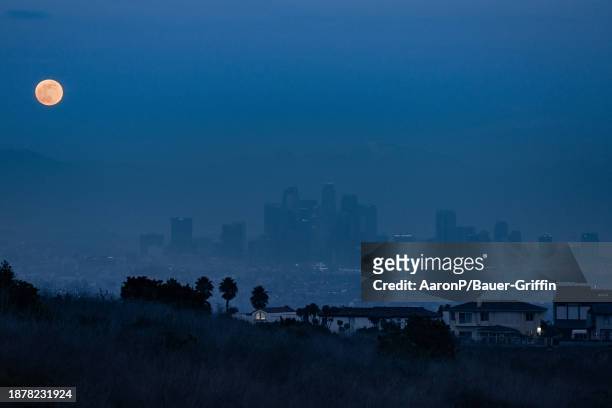 General views of the 'Cold Moon', the final full moon of 2023, rising over downtown Los Angeles on December 26, 2023 in Los Angeles, California.