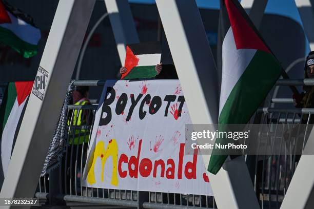 Members of the local Palestinian diaspora hold a banner that reads 'Boycott McDonald's' during the 'Action Boxing Day' protest on the WEM pedestrian...