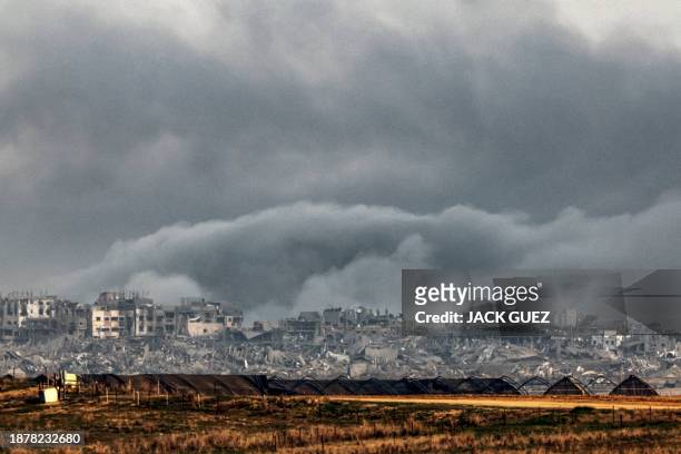 Smoke billows over the northern Gaza Strip during Israeli bombardment from southern Israel on December 27, 2023 amid continuing battles between...