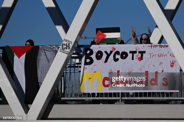 Members of the local Palestinian diaspora hold a banner that reads 'Boycott McDonald's' during the 'Action Boxing Day' protest on the WEM pedestrian...