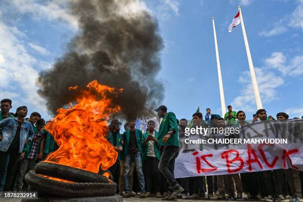 University students burn tyres as they protest against the arrival of Rohingya refugees in front of the People's Representative Council in Banda Aceh...