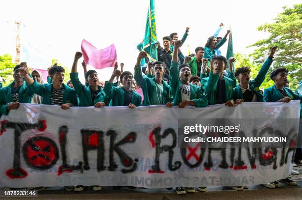 University students hold a banner that reads "reject the Rohingya" as they demonstrate against the arrival of Rohingya refugees in front of the...