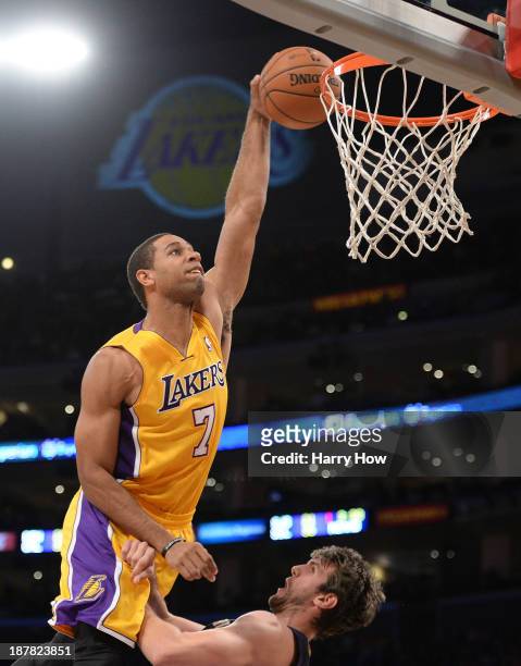 Xavier Henry of the Los Angeles Lakers dunks over Jeff Withey of the New Orleans Pelicans during a 116-95 Laker win at Staples Center on November 12,...