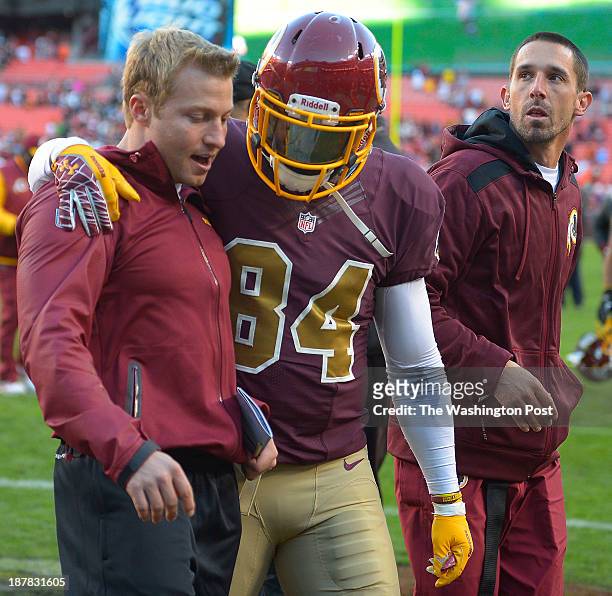 Redskins tight ends coach Sean McVay , left walks off the field with Washington tight end Niles Paul and offensive coordinator Kyle Shanahan after...