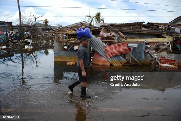 Man walks through the ruins left over Typhoon Haiyan on November 13, 2013 in Tacloban, Philippines. Haiyan, possibly the most powerful typhoon on...