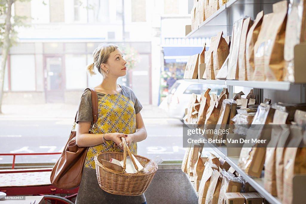 Woman shopping in delicatessen shop.