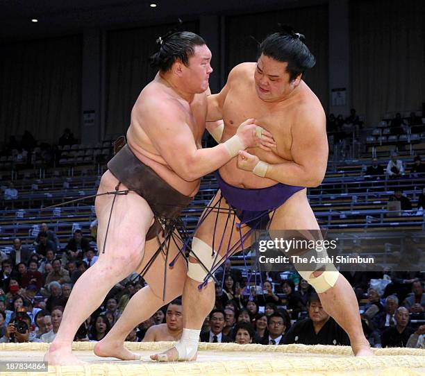 Mongolian yokozuna Hakuho , whose real name is Mnkhbatyn Davaajargal pushes Myogiryu out of the ring to win during day three of the Grand Sumo Kyushu...