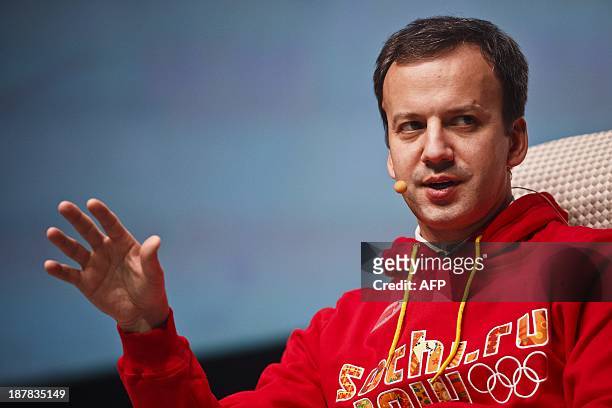 Russia's Deputy Prime Minister Arkady Dvorkovich wears a sweet-shirt with the logo of the 2014 Olympic Winter Games in Sochi as he speaks at the...