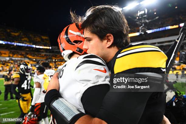 Jake Browning of the Cincinnati Bengals interacts with Mason Rudolph of the Pittsburgh Steelers after a game at Acrisure Stadium on December 23, 2023...