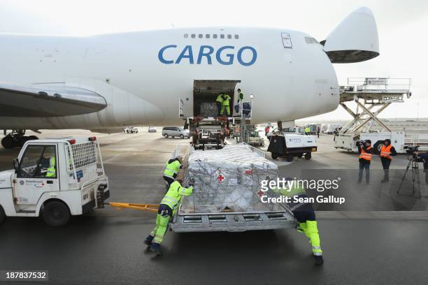 Workers load a shipment of aid from the German Red Cross destined for the Philippines on to a Boeing 747 cargo plane at Schoenefeld Airport on...
