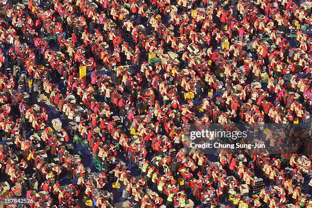 More than three thousand housewives make Kimchi for the poor in preparation for winter at the City Hall of Seoul on November 13, 2013 in Seoul, South...
