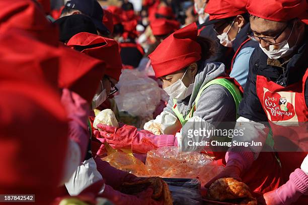 More than three thousand housewives make Kimchi for the poor in preparation for winter at the City Hall of Seoul on November 13, 2013 in Seoul, South...