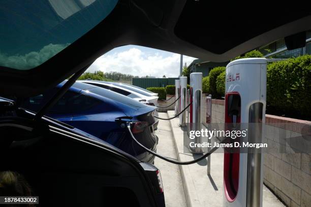 Tesla supercharger in use at Port Macquarie on December 23, 2023 in Port Macquarie, Australia. Electric cars are growing in popularity in Australia...