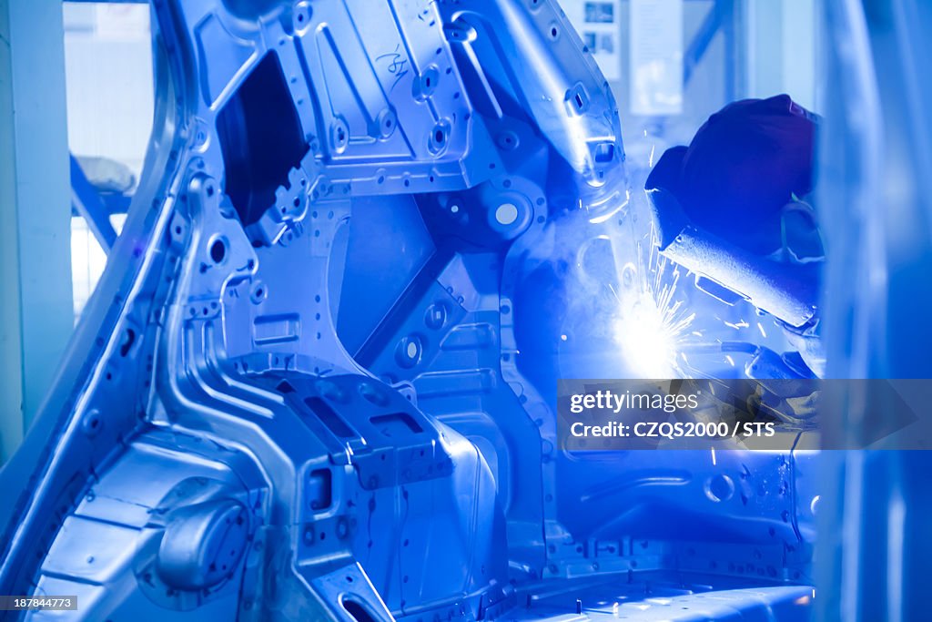 Working in automobile assembly line